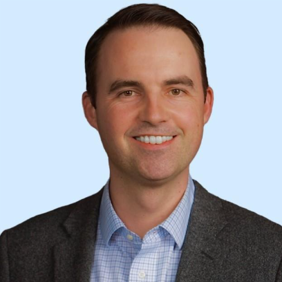 A person in a suit smiling

AI-generated content may be incorrect.