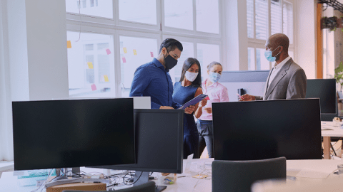 remote workers in an office with COVID protocols