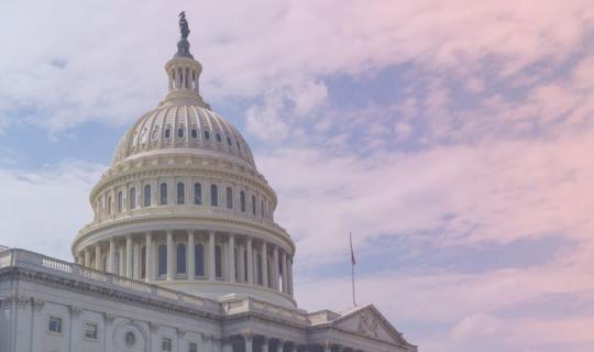A view of the capital building agiainst a sunset